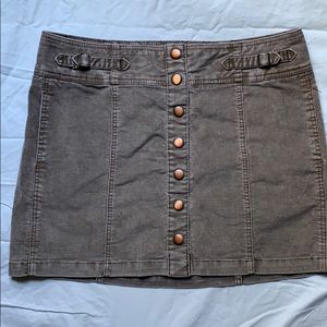 Corduroy, mini skirt with snaps down the front.
